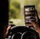 person taking a photo of trees